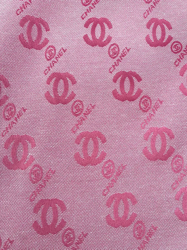 Pink fabric with red Chanel logo pattern