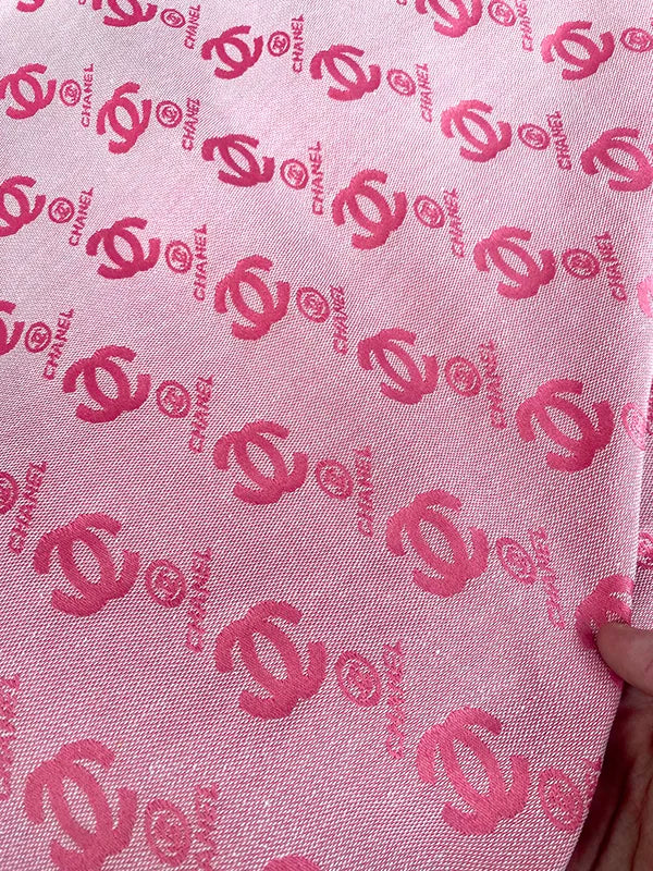 Pink fabric with red Chanel logo pattern